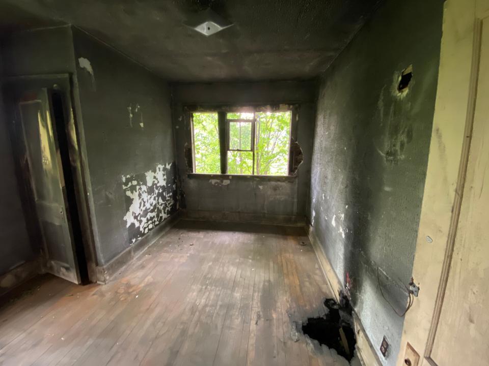 detroit land bank authority room with black walls and holes