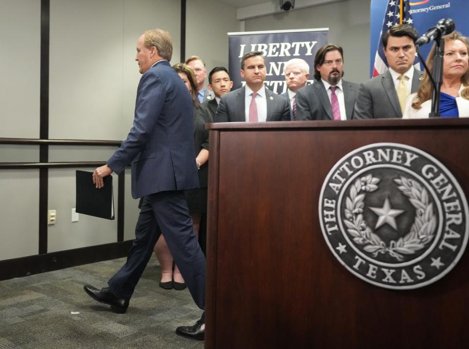 Attorney General Ken Paxton walks away without answering questions at a news conference at the Price Daniel State Office Building on Friday May 26, 2023.