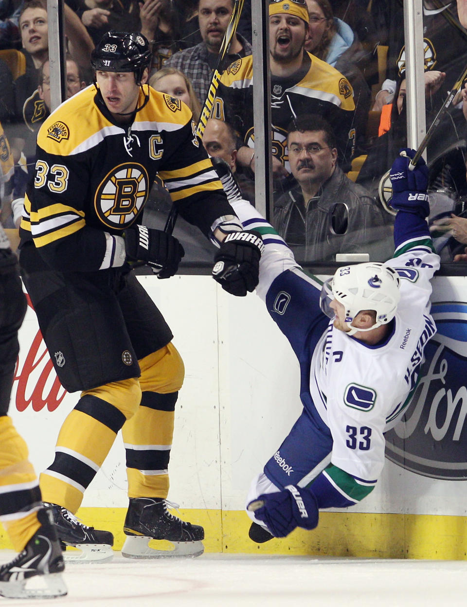 BOSTON, MA - JANUARY 07: Zdeno Chara #33 of the Boston Bruins checks Henrik Sedin #33 of the Vancouver Canucks on January 7, 2012 at TD Garden in Boston, Massachusetts. (Photo by Elsa/Getty Images)