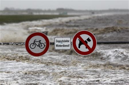 Traffic signs are seen on the North Sea beach near the town of Norddeich, December 5, 2013. REUTERS/Ina Fassbender