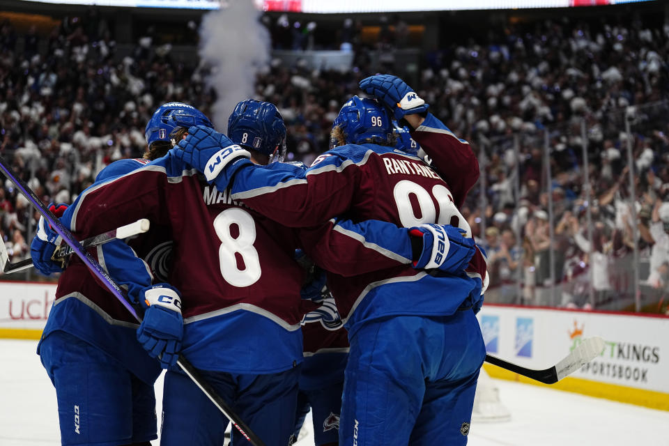 Colorado Avalanche right wing Mikko Rantanen (96) celebrates a goal against the Seattle Kraken with Cale Makar (8) and Nathan MacKinnon (29) during the first period of Game 1 of a first-round NHL hockey playoff series Tuesday, April 18, 2023, in Denver. (AP Photo/Jack Dempsey)