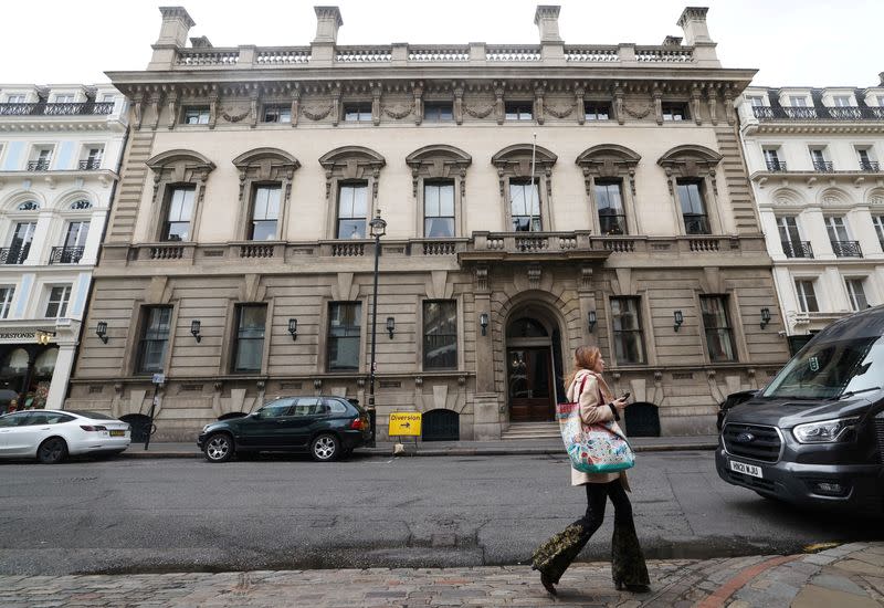 FILE PHOTO: A person walks past the entrance to the Garrick Club in London