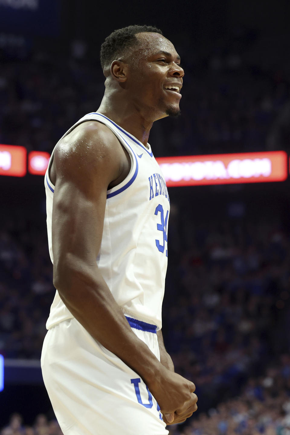 Kentucky's Oscar Tshiebwe (34) celebrates a made shot during the first half of an NCAA college basketball game against Louisville in Lexington, Ky., Saturday, Dec. 31, 2022. (AP Photo/James Crisp)