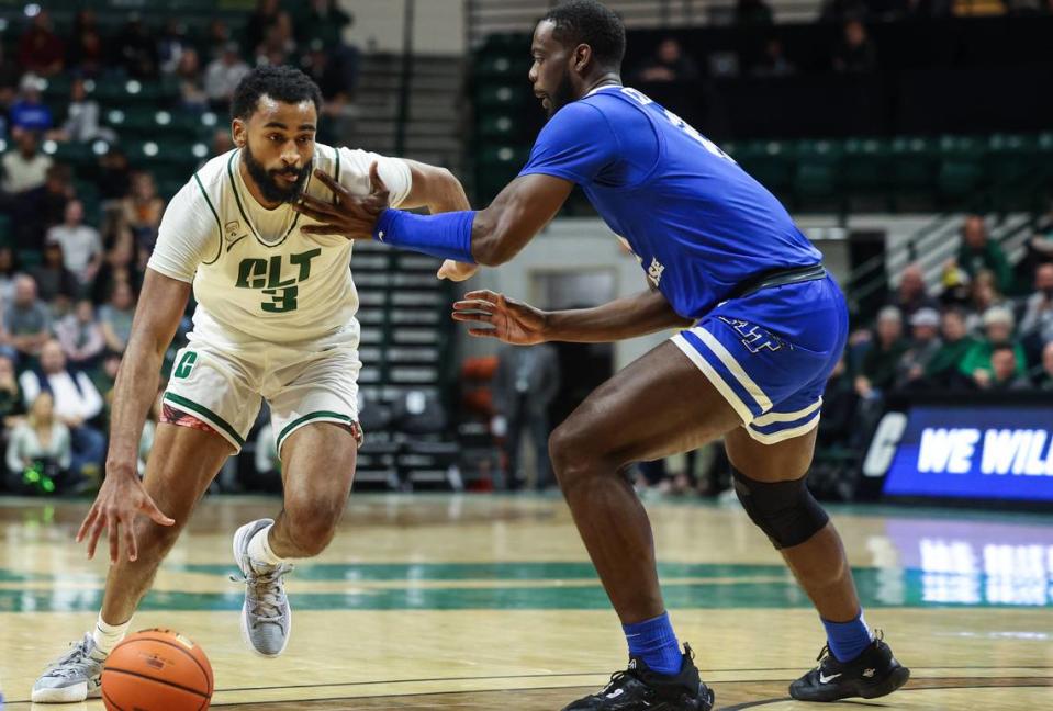 UNC Charlotte’s Brice Williams, left, drives past Middle Tennessee’s Jared Coleman-Jones during the game against Middle Tennessee at Dale F. Halton Arena on Thursday, December 29, 2022. Charlotte defeated Middle Tennessee, 82-67.