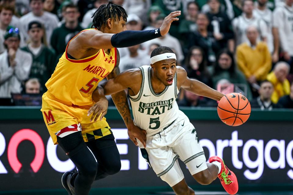 Michigan State's Tre Holloman, right, moves the ball as Maryland DeShawn Harris-Smith defends during the second half on Saturday, Feb. 3, 2024, at the Breslin Center in East Lansing.