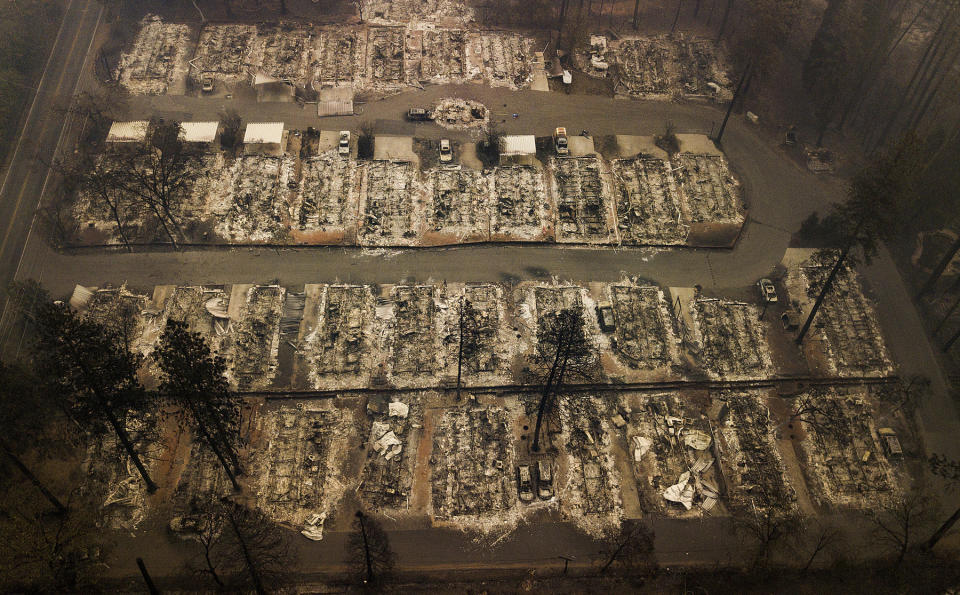 FILE - This Thursday, Nov. 15, 2018, file aerial photo shows the remains of residences leveled by the wildfire in Paradise, Calif. Facing potentially colossal liabilities over deadly California wildfires, PG&E will file for bankruptcy protection. The announcement Monday, Jan. 14, 2019, follows the resignation of the power company’s chief executive. (AP Photo/Noah Berger, File)