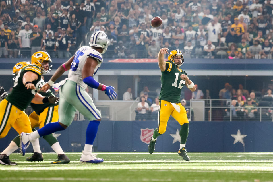 ARLINGTON, TX - OCTOBER 08: Green Bay Packers quarterback Aaron Rodgers (12) makes a pass while scrambling during the football game between the Green Bay Packers and Dallas Cowboys on October 8, 2017 at AT&T Stadium in Arlington, TX.  (Photo by Andrew Dieb/Icon Sportswire via Getty Images)