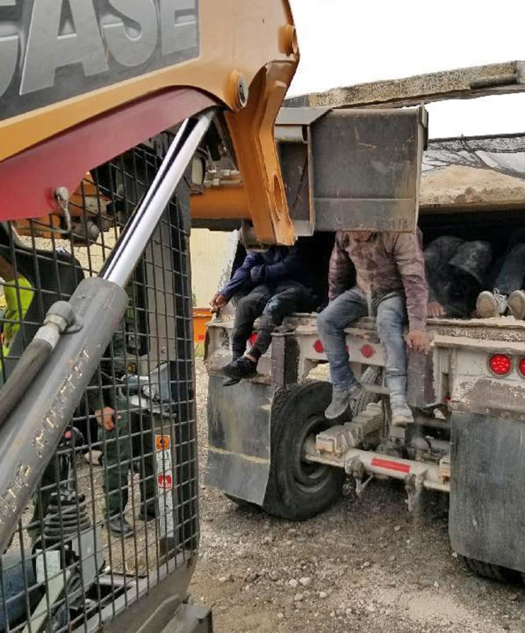 The Heavy duty vehicle is a dump truck that possessed plywood sheets affixed to the center of the container.  This modification created two separate containers.  The bottom container concealed the 36 illegal immigrants.