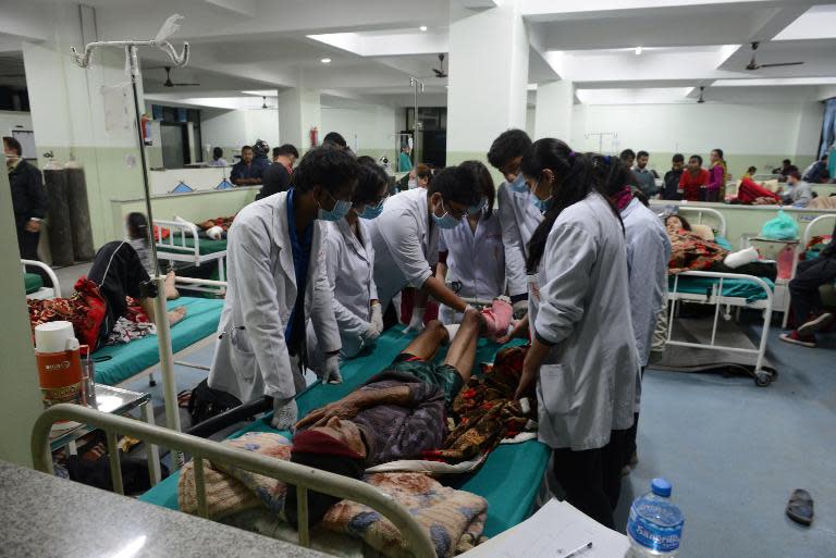 People injured in a devastating earthquake receive treatment at a hospital in Kathmandu on April 28, 2015