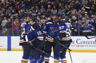 St. Louis Blues left wing Brandon Saad (20) is congratulated after scoring a goal against the Calgary Flames during the second period of an NHL hockey game Thursday, Jan. 27, 2022, in St. Louis. (AP Photo/Joe Puetz)