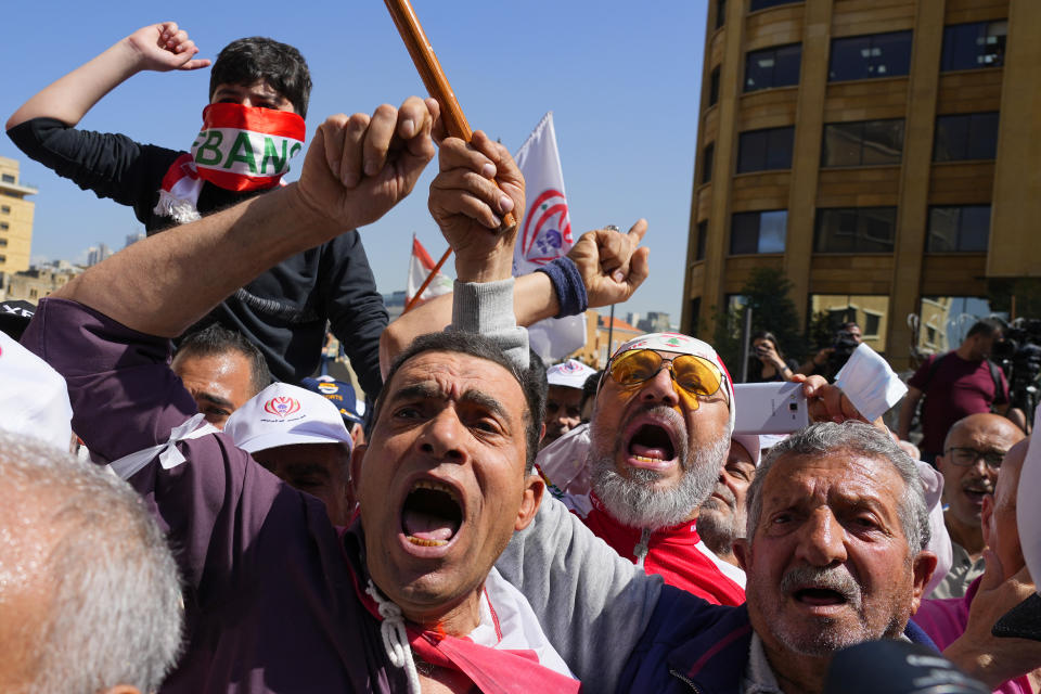 Retired members of the Lebanese security forces and other protesters, shout slogans during a protest demanding better pay and living conditions in Beirut, Lebanon, Tuesday, April 18, 2023. Earlier in the day, Lebanon's Parliament voted to postpone municipal elections that had been planned for May 2023 in the crisis-stricken country by up to a year. (AP Photo/Bilal Hussein)