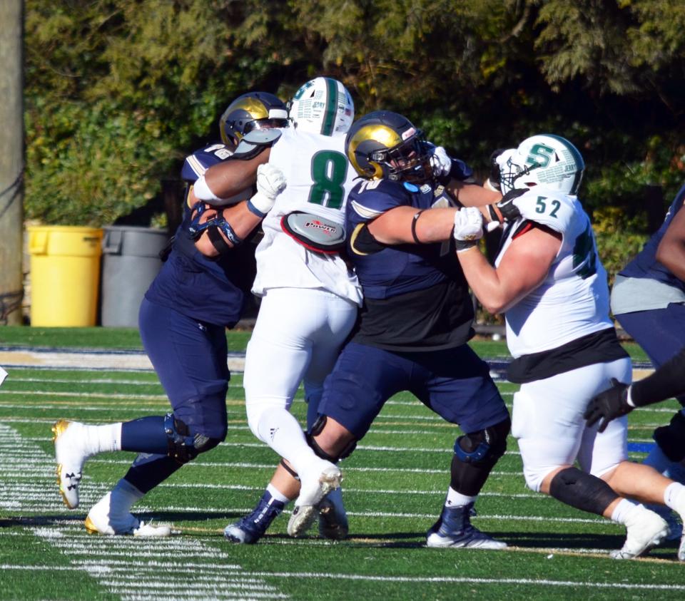 Shepherd offensive tackle Joey Fisher, left, holds off Slippery Rock defensive end D.J. Adediwura (8) in a battle between two finalists for the Gene Upshaw Division II Lineman of the Year Award.