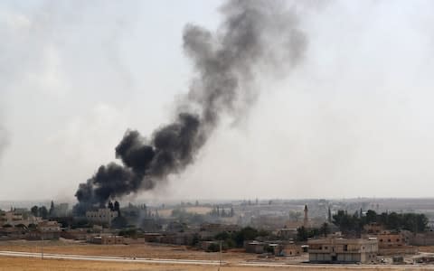 Smoke rises from a Turkish bombardment in northeast Syria, seen from the Turkish side of the border - Credit: ERDEM SAHIN/EPA-EFE/REX
