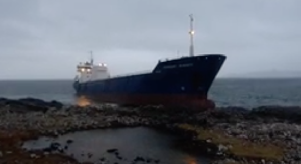 Large cargo ship hits rocks and runs aground in Scotland