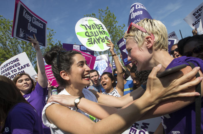 <p>Abortion rights activists Morgan Hopkins of Boston, left, and Alison Turkos of New York City, rejoice in front of the Supreme Court as the justices struck down the strict Texas anti-abortion restriction law known as HB2. (J. Scott Applewhite/AP) </p>