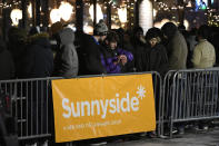 A long line of people brave the cold as they wait to be the first in Illinois to purchase recreational marijuana at Sunnyside dispensary Wednesday, Jan. 1, 2020, in Chicago. (AP Photo/Paul Beaty)