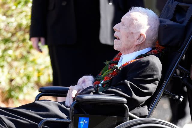 <p>John Bazemore/AP Photo</p> Jimmy Carter in a red lei