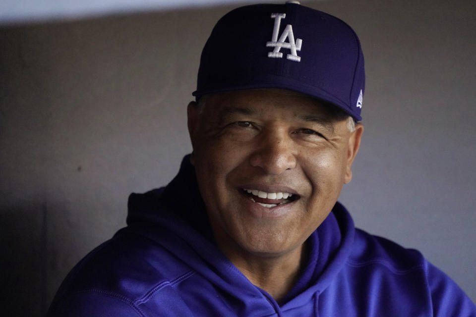 Los Angeles Dodgers manager Dave Roberts sits in the dugout during batting practice before Game 4 of the baseball team's National League Division Series against the San Francisco Giants, Tuesday, Oct. 12, 2021, in Los Angeles. (AP Photo/Marcio Jose Sanchez)