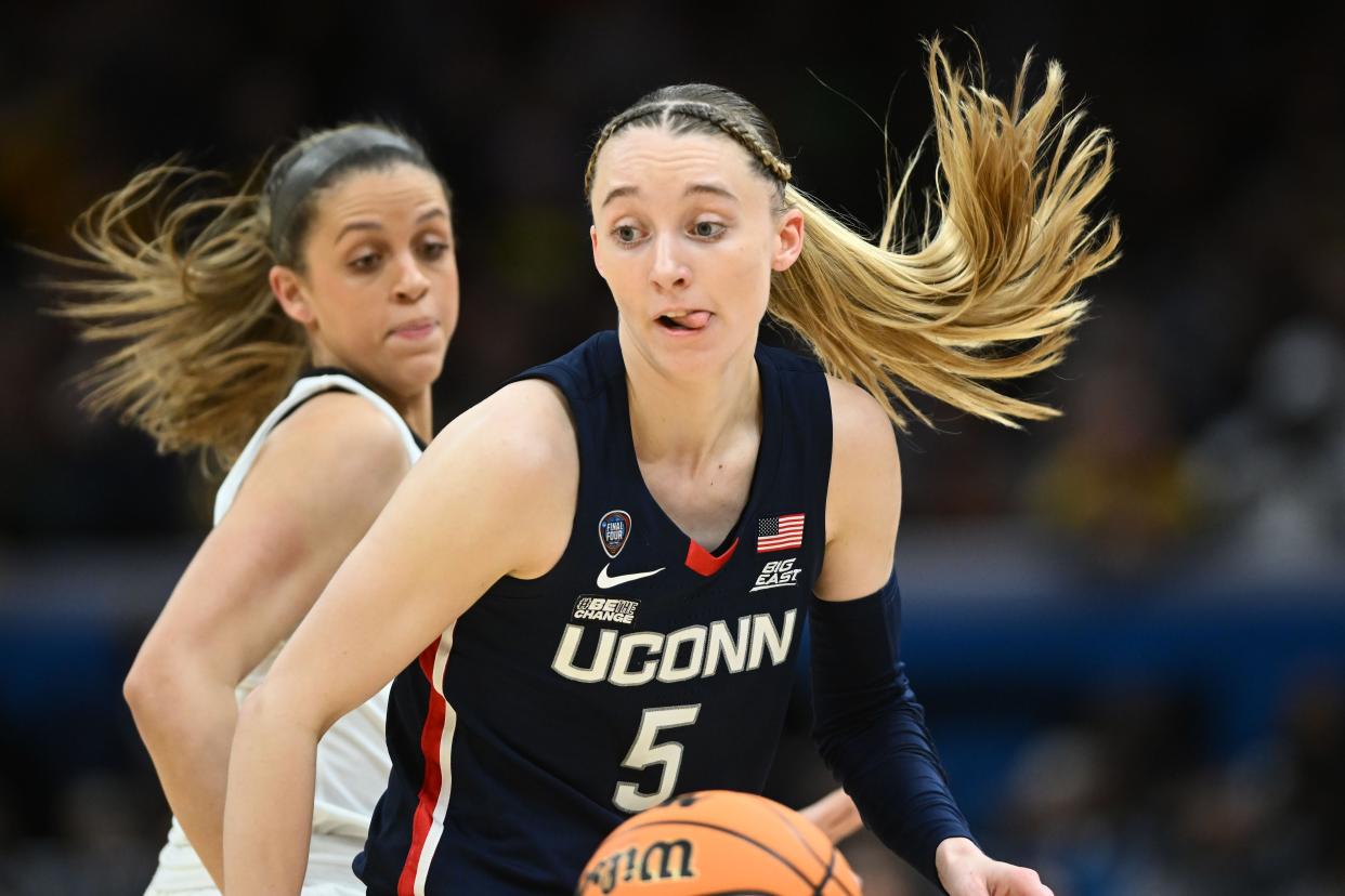 Connecticut guard Paige Bueckers (5) dribbles the ball against Iowa in Friday's national semifinal game at Rocket Mortgage FieldHouse.