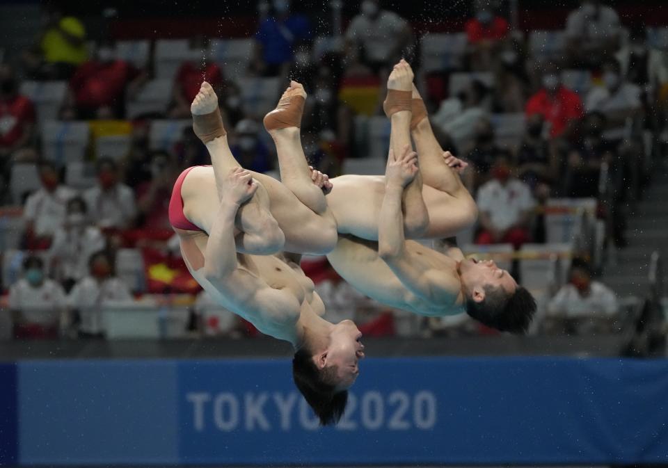 Wang Zongyuan and Xie Siyi of China compete during the men's Synchronized 3m Springboard Final at the Tokyo Aquatics Centre at the 2020 Summer Olympics, Wednesday, July 28, 2021, in Tokyo, Japan. (AP Photo/Dmitri Lovetsky)