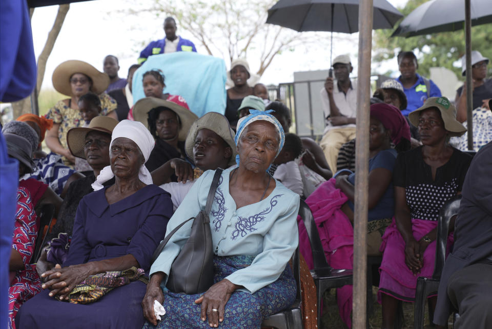 Family members attend the burial of Moreblessing Ali, on the outskirts of Harare, Saturday, March, 2, 2024. A Zimbabwean activist slain two years ago was finally laid buried Saturday at a low key but tension filled event where tensions among party members betrayed the state of the country once promising opposition, which appears collapsing under the weight of infighting and allied state repression. (AP Photo/Tsvangirayi Mukwazhi)