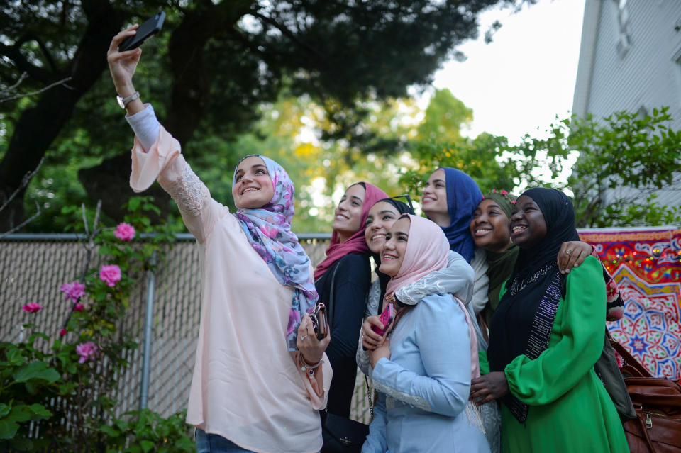 Dina Sayedahmed, an Egyptian American Muslim with a major in journalism and political science from Rutgers University, is embraced as she poses for a selfie in her family's backyard in preparation for her graduation celebration and Iftar feast during Ramadan in Bayonne, New Jersey, U.S. June 2, 2017. Picture taken June 2, 2017. REUTERS/Amr Alfiky