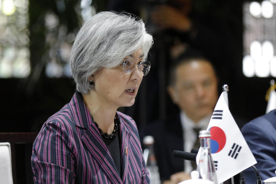 South Korean Foreign Minister Kang Kyung-wha, center, speaks with her Japanese counterpart Taro Kono and Chinese counterpart Wang Yi during their trilateral meeting at Gubei Town in Beijing Wednesday, Aug. 21, 2019. (Wu Hong/Pool Photo via AP)