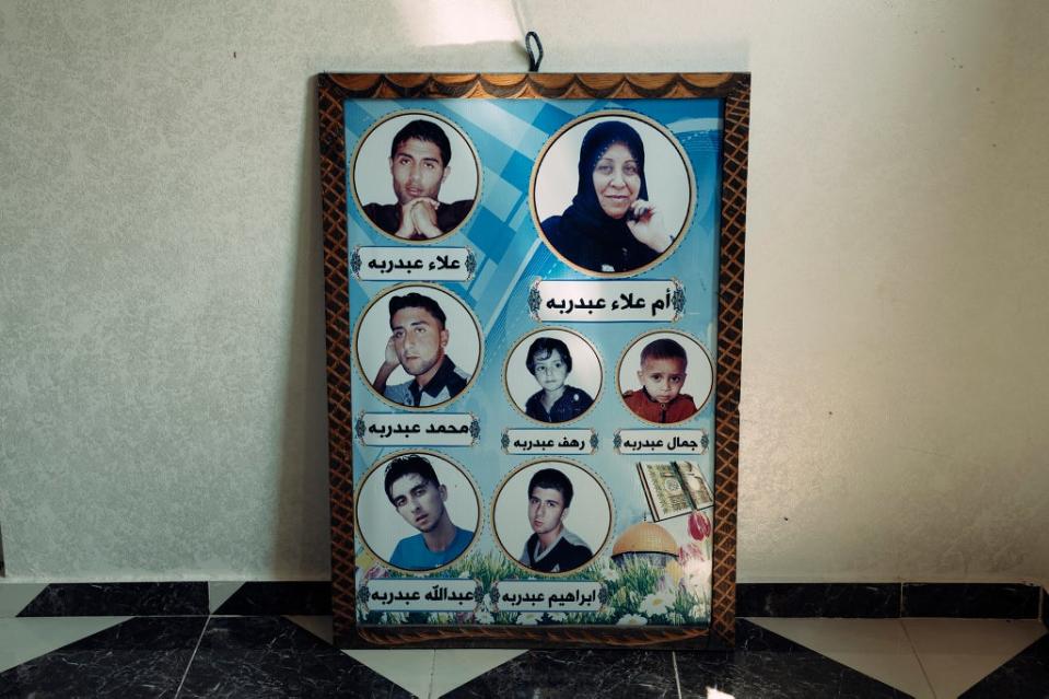 A framed poster in Baraka’s family home, showing the faces and names of some of the family members who were killed while seeking shelter (Paddy Dowling/Qatar Fund For Development)