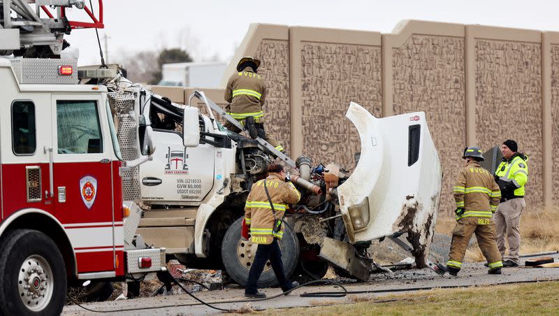 Firefighters work the scene as crews sort out and clean up after a fatal accident on Mountain View Corridor and 3500 South in West Valley City on Jan. 16, 2023.