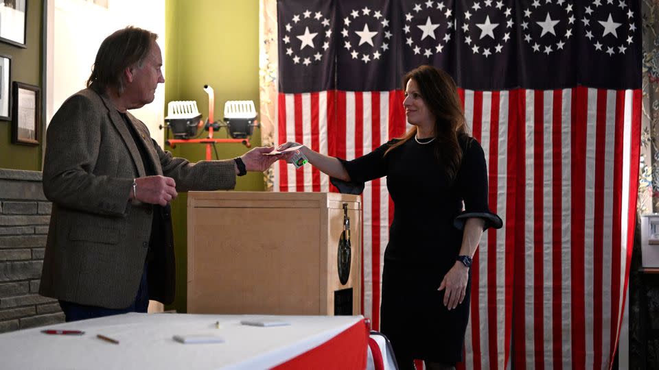 A voter casts her ballot in the First-in-the-Nation midnight vote for the New Hampshire primary elections in the Living Room of the Tillotson House at the Balsams Grand Resort in Dixville Notch, New Hampshire, on January 23, 2024. - Sebastien St-Jean/AFP/Getty Images