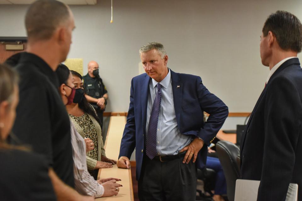 Tom Bakkedahl (center), State Attorney for the 19th Judicial Circuit, talks with the family of Richard Brighton on Monday, Aug. 11, 2021, at the St. Lucie County Courthouse in Fort Pierce. Richard Brighton was shot to death, along with his wife Penny, by their son Jacob Brighton in Aug. 2007, at their home in Fort Pierce. Jacob Brighton was resentenced, by Circuit Judge William Roby, to two consecutive life sentences without the possibility for parole, for the murder of both his parents when he was 16.