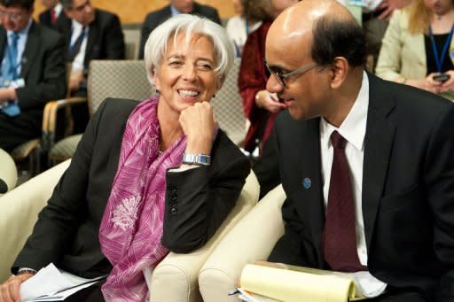 International Monetary Fund (IMF) Managing Director Christine Lagarde and Singapore Finance Minister and International Monetary and Financial Committee (IMFC) chair Tharman Shanmugaratnam chat before the start of the International Monetary and Financial Committee (IMFC) plenary session at the IMF/World Bank Annual Spring Meetings in Washington