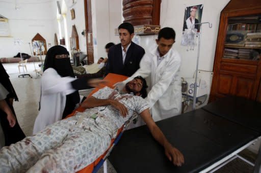 A wounded Yemeni dissident tribesman is carried on a stretcher at a makeshift clinic outside Sanaa University on June 1. Thousands of armed tribesmen were headed towards Sanaa to back their leader Sheikh Sadiq al-Ahmar, whose fighters are locked in deadly battles with Yemen's security forces, tribal leaders said