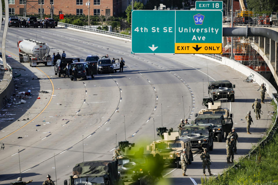 A semi-truck involved in an incident with protesters on Highway 35W is surrounded by authorities, Sunday, May 31, 2020, in St. Paul, Minn. Protests continued following the death of George Floyd, who died after being restrained by Minneapolis police officers on May 25. (AP Photo/John Minchillo)