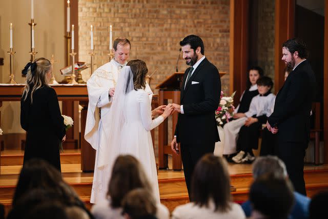 <p>Adam Kennedy Photography</p> Kevin and Catie Zwier standing at the altar