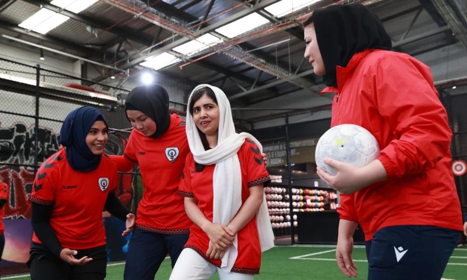 Malala Yousafzai standing with players from the Afghanistan women’s team.