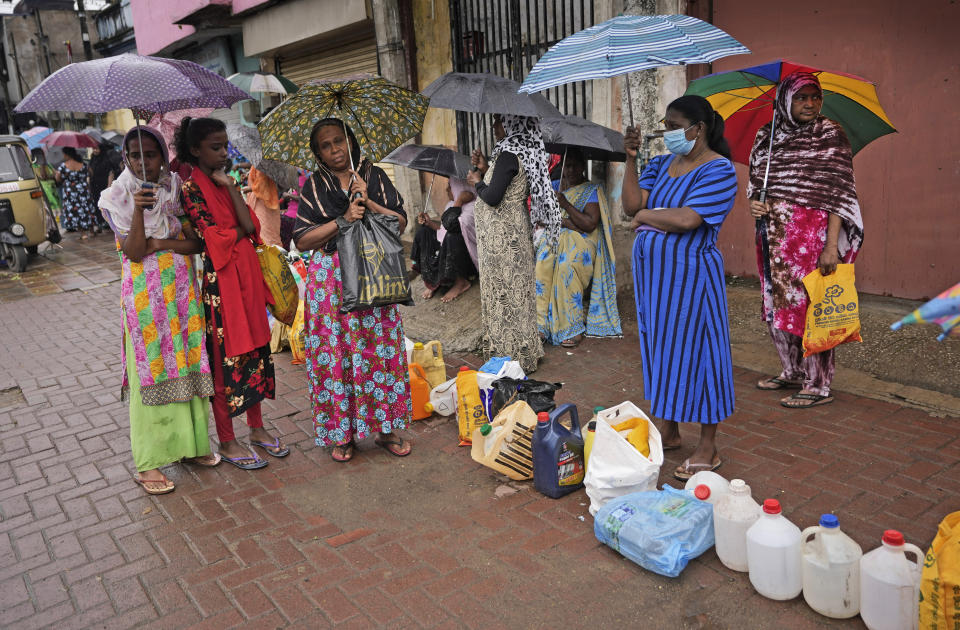 Women wait in a queue to buy kerosene in in Colombo, Sri Lanka, Saturday, June 11, 2022. Sri Lanka's economic crisis, the worst in its history, has completely recast the lives of the country's once galloping middle class. For many families that never had to think twice about fuel or food, the effects have been instant and painful, derailing years of progress toward lifestyles aspired to across South Asia. (AP Photo/Eranga Jayawardena)