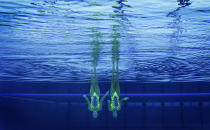 Italy's Giulia Lapi and Mariangela Perrupato are seen underwater as they perform in the synchronised swimming duets technical routine qualification round during the London 2012 Olympic Games at the Aquatics Centre August 5, 2012. REUTERS/Tim Wimborne (BRITAIN - Tags: SPORT OLYMPICS SWIMMING TPX IMAGES OF THE DAY)