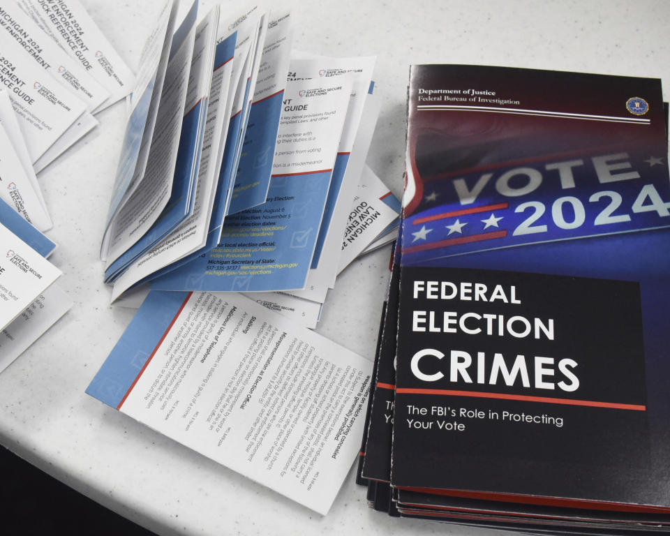 Educational materials provided by the Committee of Safe and Secure Elections are pictured at a conference with local election and law enforcement officials Wednesday, April 10, 2024, in Traverse City, Mich. A top concern for local election workers throughout the country this year is their own safety. The committee, formed after the 2020 presidential election, is traveling the country helping them prepare for what could lie ahead and making sure they are connected to local law enforcement. (AP Photo/John L. Russell)