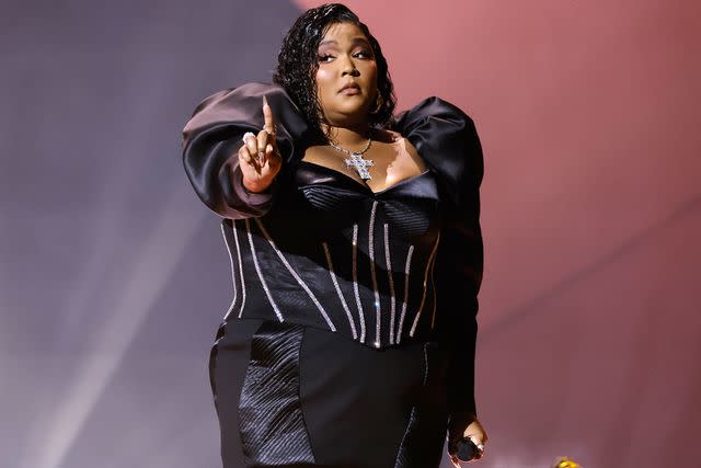 Kevin Winter/Getty Lizzo performing at the Grammy Awards in February 2023