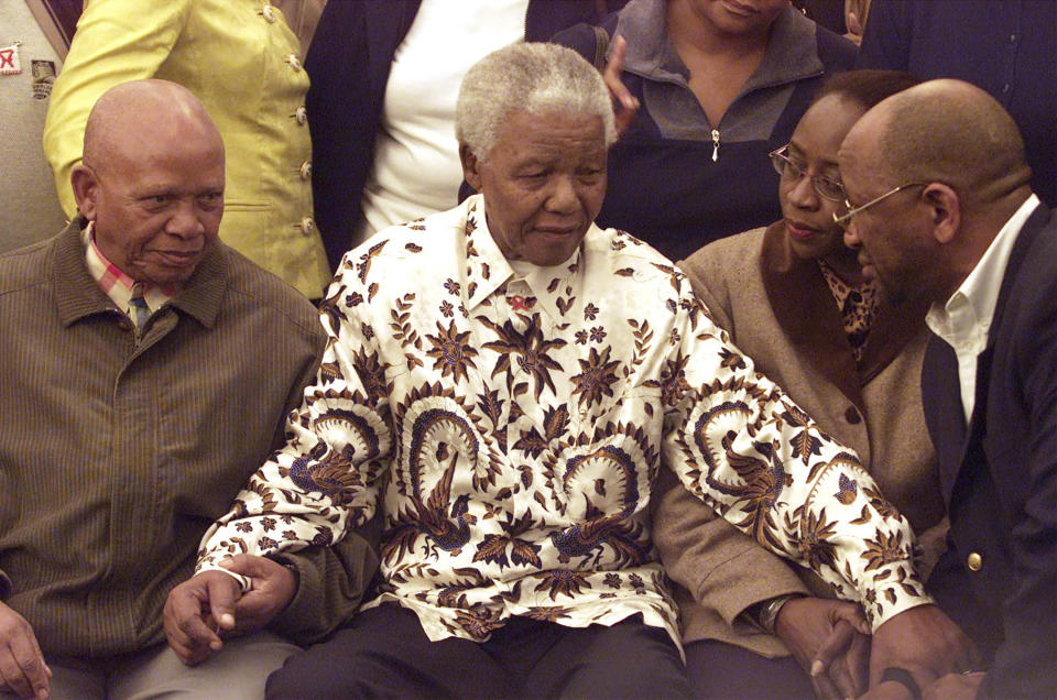 FILE - Former South African President and African National Congress (ANC) leader Nelson Mandela, center, is greeted in Johannesburg, on July 18, 2003, at his 85th birthday celebrations. South Africa is in a moment of deep soul-searching after an election that brought a jarring split from the ANC, the very party that gave the country freedom and democracy 30 years ago. (AP Photo/Themba Hadebe, File)