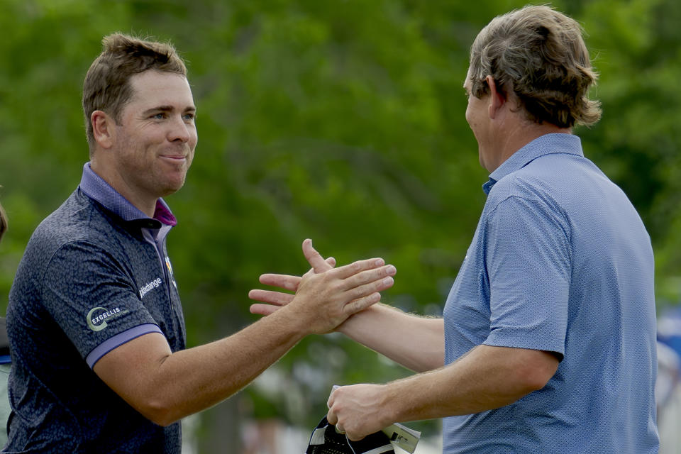 Luke List, left, congratulates Henrik Norlander on the 18th green during the third round of the Zurich Classic golf tournament at TPC Louisiana in Avondale, La., Saturday, April 27, 2024. (AP Photo/Matthew Hinton)