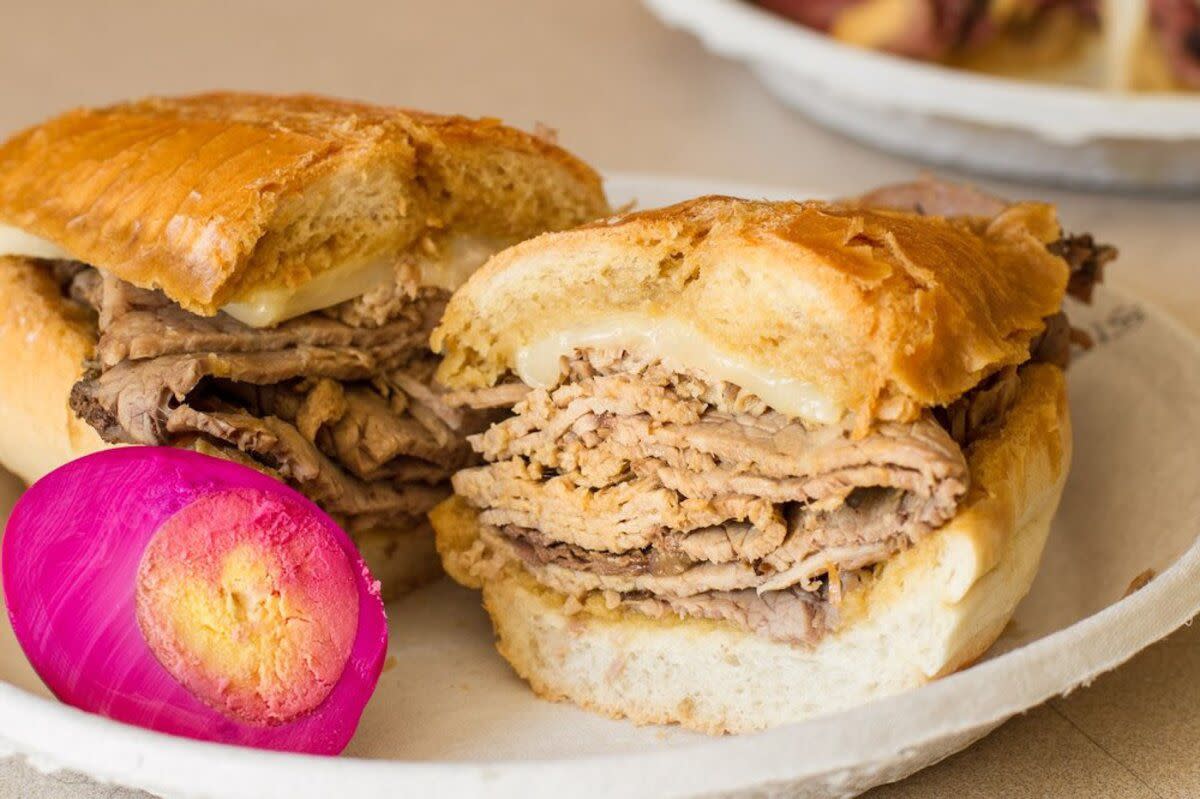 Closeup of French Dip Sandwich on a paper plate with a magenta hard boiled egg, Philippe The Original, Los Angeles