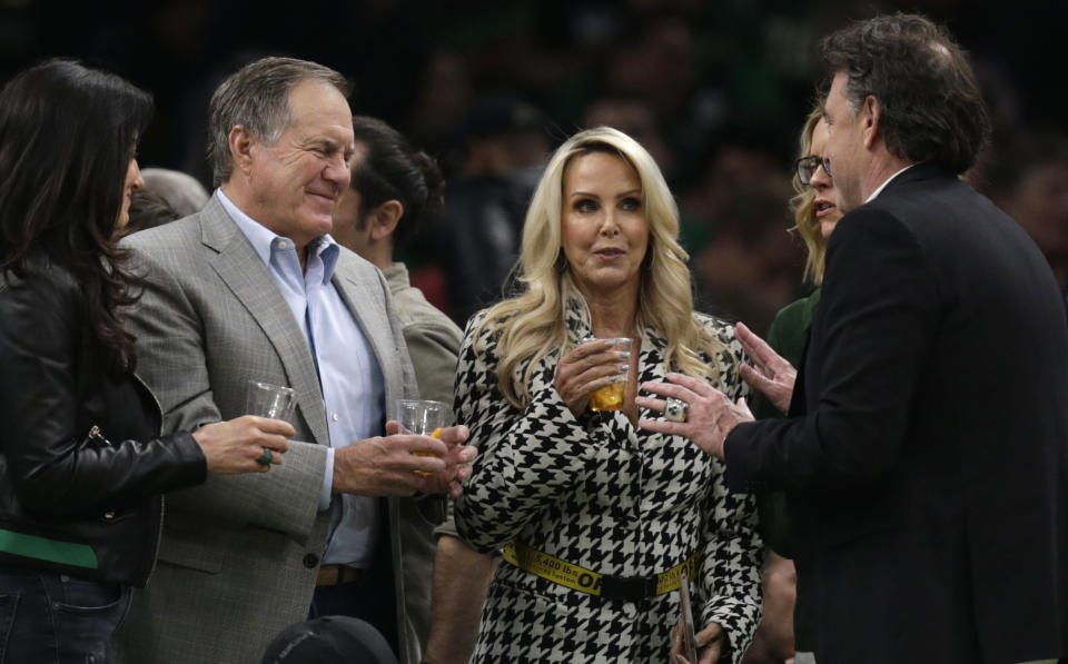New England Patriots head coach Bill Belichick talks with Boston Celtics owner Wyc Grousbeck, right, during the second quarter of Game 2 of an NBA basketball first-round playoff series, Wednesday, April 17, 2019, in Boston. Second from right is Belichick's girlfriend Linda Holliday, at left is Grousbeck's wife Emilia Fazzalari. (AP Photo/Charles Krupa)