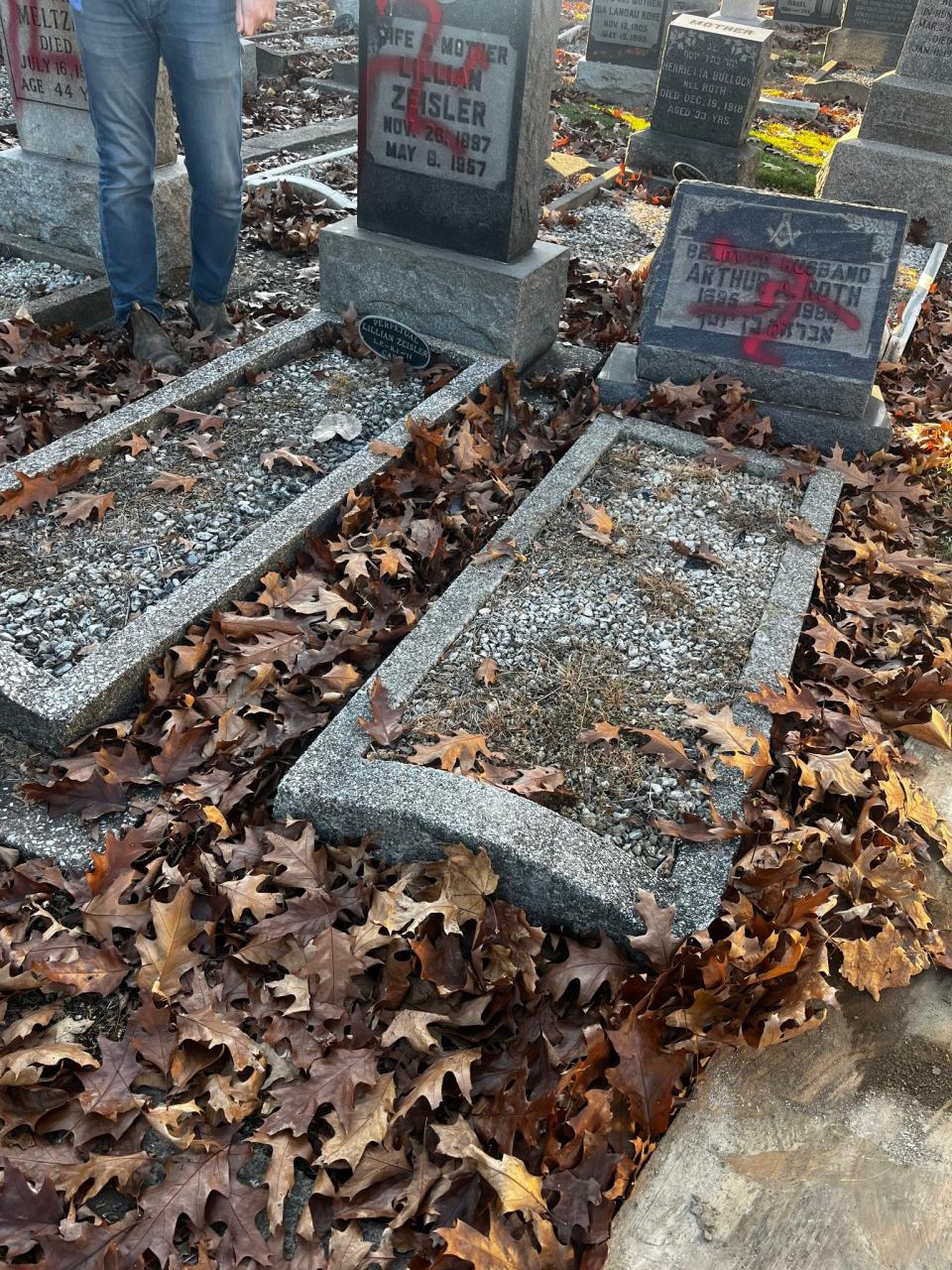 Volunteers removed graffiti that included swastikas at a Jewish Cemetery in Brooklyn, near Cleveland, on Sunday.