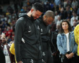 Houston Rockets guard Austin Rivers and forward P.J. Tucker react during a tribute to NBA star Kobe Bryant before an NBA basketball game against the Denver Nuggets, Sunday, Jan. 26, 2020, in Denver. Bryant died in a California helicopter crash Sunday. (AP Photo/David Zalubowski)