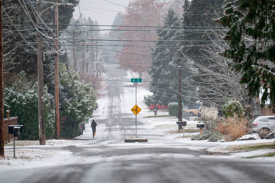 A jogger makes their way through the snow on 82nd Street on Tuesday, Nov. 29, in Tacoma. Many people in the South Puget Sound woke up to snow on Tuesday. More snow is expected later in the week.