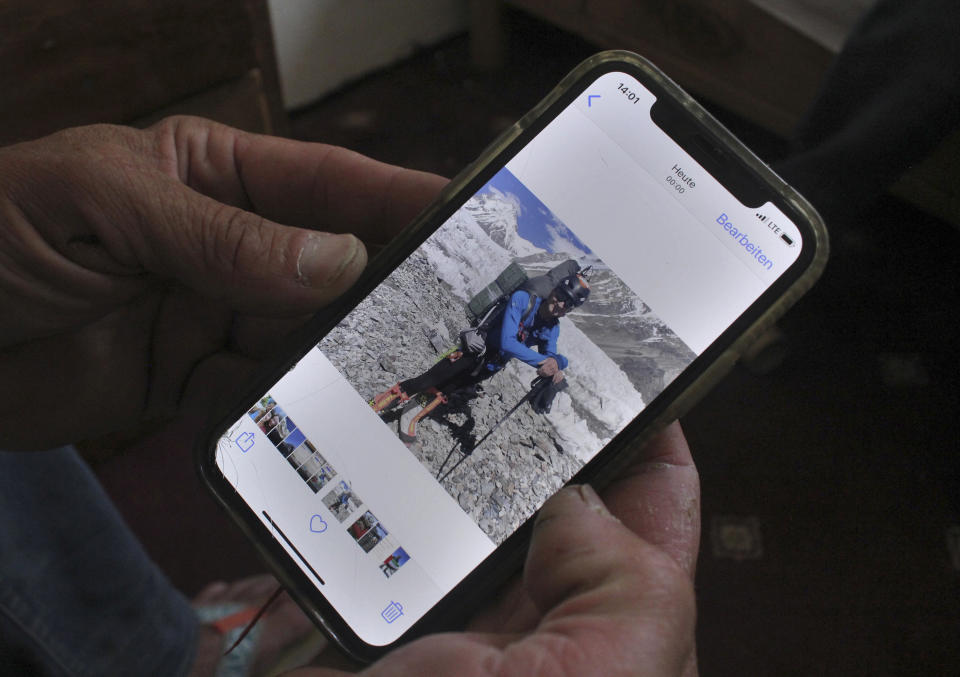 Austrian climber Stephen Keck, one of two mountain climbers who survived an avalanche and were subsequently rescued, shows a picture of a third climber, Rick Allen on his mobile phone during an interview with The Associated Press, in Skardu, a town in the Gilgit Baltistan region of northern Pakistan, Monday, July 26, 2021. Allen, a renowned Scottish climber died in the avalanche while attempting to scale K2 in northern Pakistan, the world's second-highest mountain peak, a Pakistani mountaineering official and the U.K.-based charity Partners Relief & Development said Monday. (AP Photo/M.H. Balti)