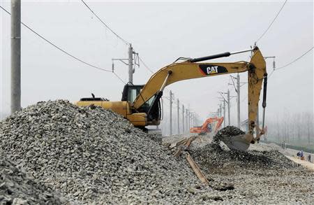 Excavators repair a section of the new Hanyi High-speed Railway that collapsed in Nanwan Village of Qianjiang, Hubei province in this March 12, 2012 file photo. REUTERS/China Daily/Files