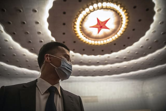 A security official wearing protective face mask stands guard before the second plenary session of China’s National People’s Congress (NPC) at the Great Hall of the People in Beijing 